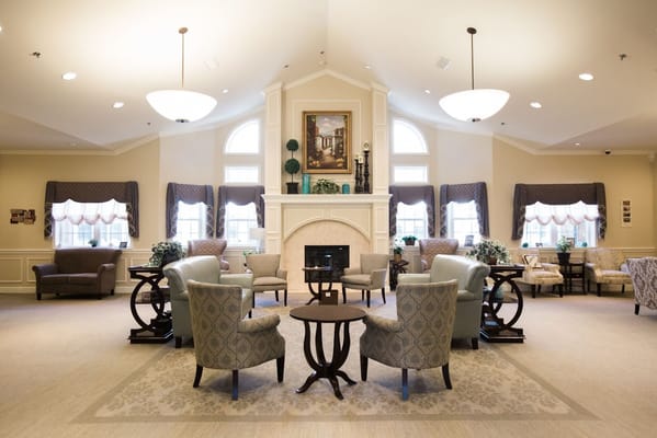 Cozy living room with seating, fireplace, and large windows