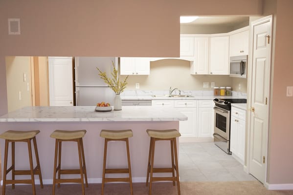 Bright kitchen area with bar stools