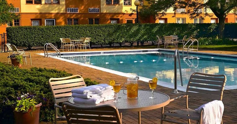Outdoor pool area with seating and drinks