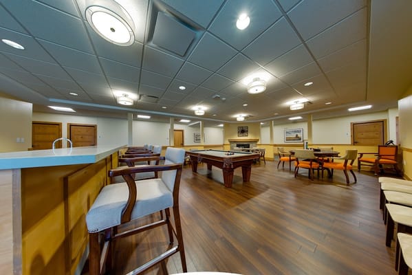 Bright common area with seating and game tables