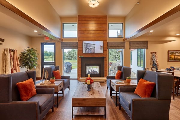 Spacious lounge with comfortable seating and a fireplace