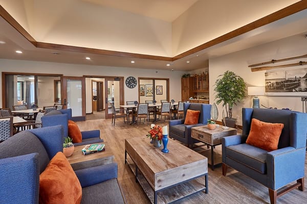 Inviting lounge area with blue chairs and wooden tables