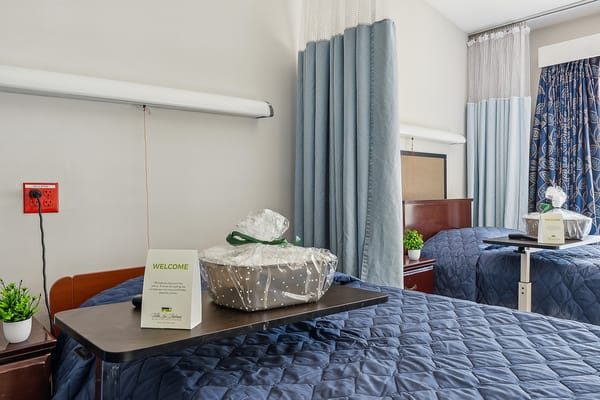 Well-decorated bedroom featuring a welcome sign and a gift basket
