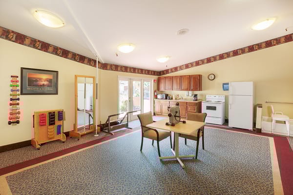 Interior view of the activity room with fitness equipment and kitchenette