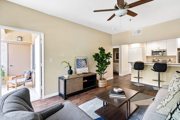 Cozy living room with modern furnishings and kitchen view
