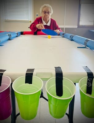 Resident engaging in a fun ping pong game