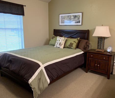 Cozy bedroom setup with a large bed and bedside table