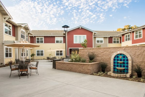 Outdoor courtyard with seating and decorative fountain