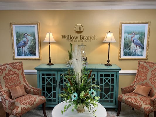 Interior lobby area with artwork and lamps