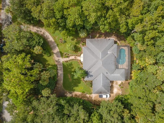 Aerial view of a large senior living facility surrounded by trees