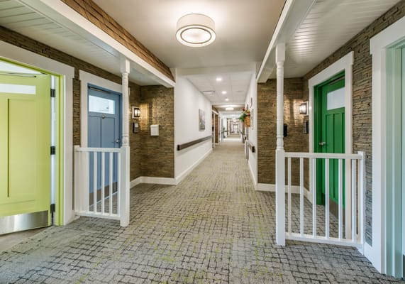 Interior hallway with colorful doors and lighting