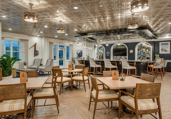 Spacious dining area with wooden tables and a bar
