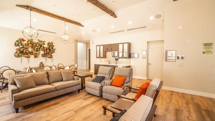 Bright living room with comfortable seating and a kitchenette