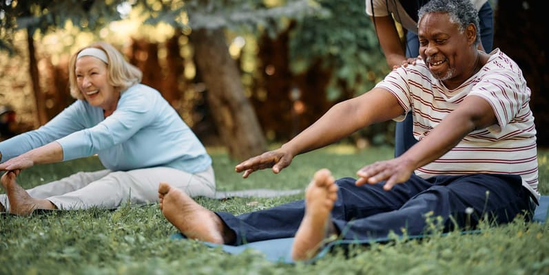 Residents participating in outdoor stretching activity