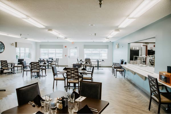 Bright dining room with tables set for meals