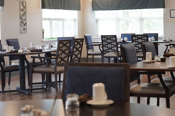 Dining area with tables set up for residents