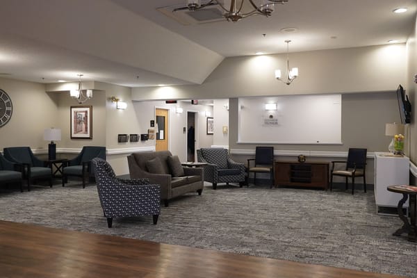 Common area with seating and decor in a senior living facility