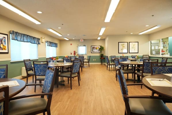 Bright dining area with tables and chairs set up