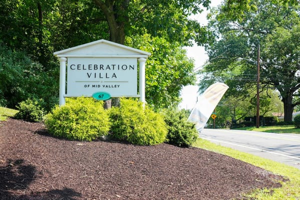 Sign for Celebration Villa of Mid Valley surrounded by greenery