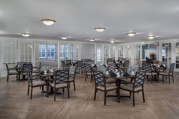 Bright dining area with multiple tables set for meals