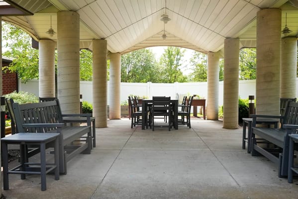 Covered outdoor seating area with tables and chairs