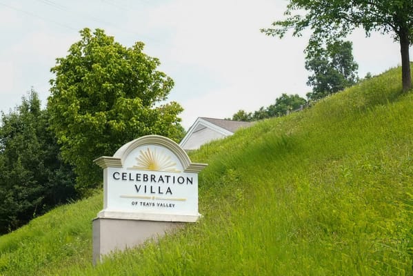 Sign for Celebration Villa of Teays Valley on a green hillside