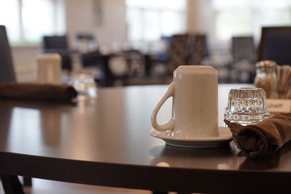 Close-up of a dining table set with coffee cups