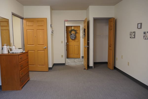 Interior view of a private resident room with doors open