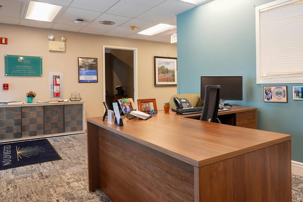 Bright reception area with desk and computer