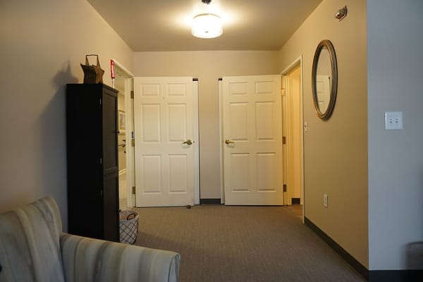 Interior hallway with doors and lighting fixture