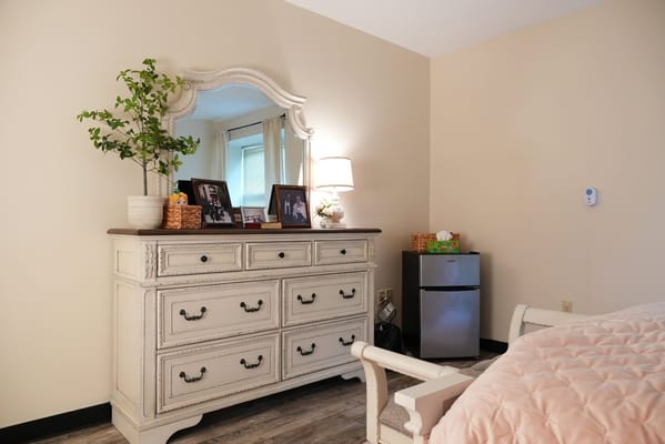 Cozy resident room with dresser and mirror