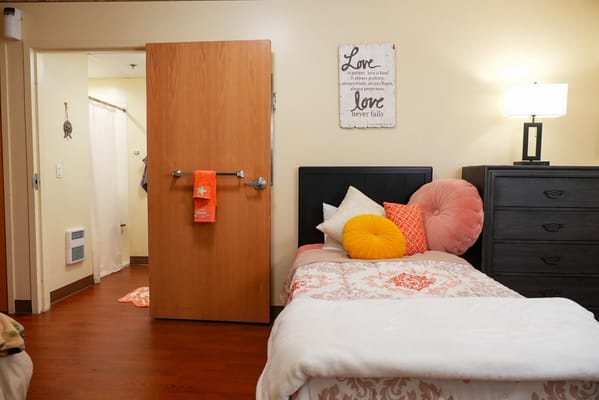 Cozy resident room with bed and decorative items