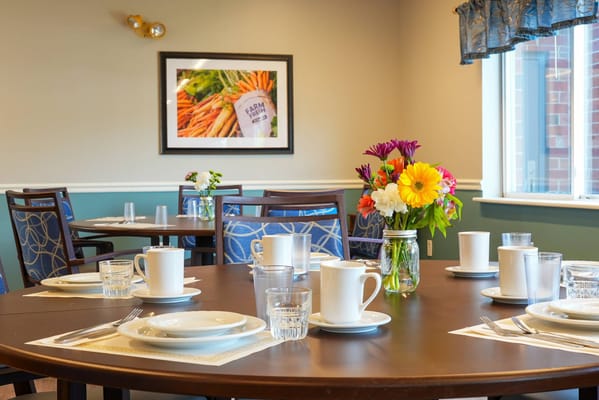 Dining room set up with flowers and tableware