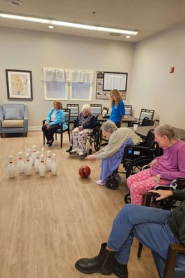 Residents bowling in a common area activity