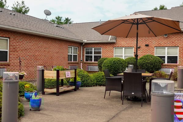 Outdoor seating area with tables and an umbrella