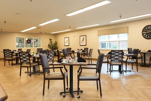 Dining area with tables and chairs in a well-lit room