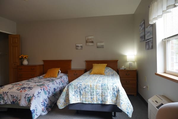 A cozy shared bedroom with two beds and decor