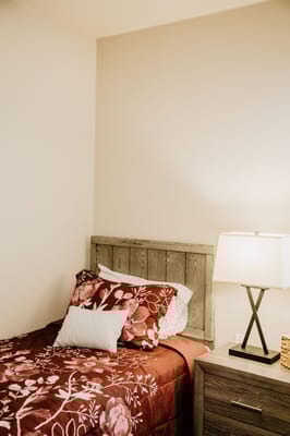 Cozy bedroom with floral bedding and lamp
