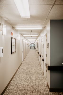 Well-lit hallway inside a senior living facility
