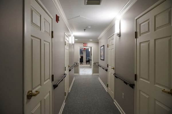 Well-lit hallway with doors and accessible features