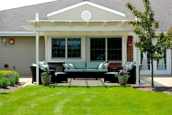 Outdoor seating area with lounge chairs and flowering pots