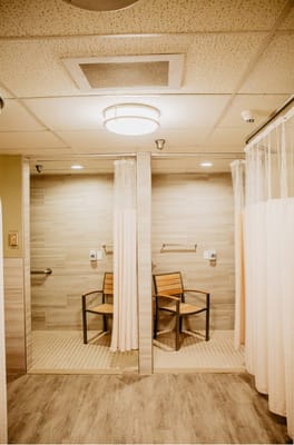 Interior shower area with two chairs and curtains