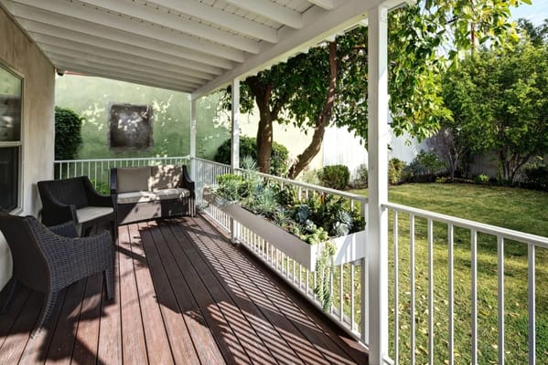 Patio area with seating and greenery