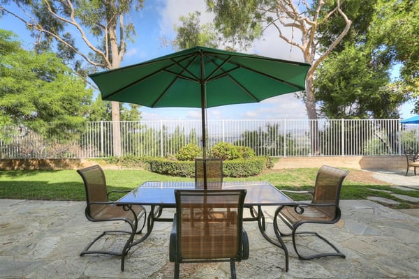 Outdoor dining area with chairs and umbrella