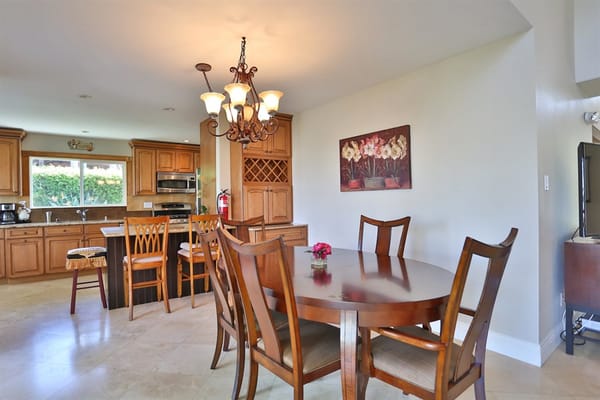 Dining area with wooden furniture and chandelier