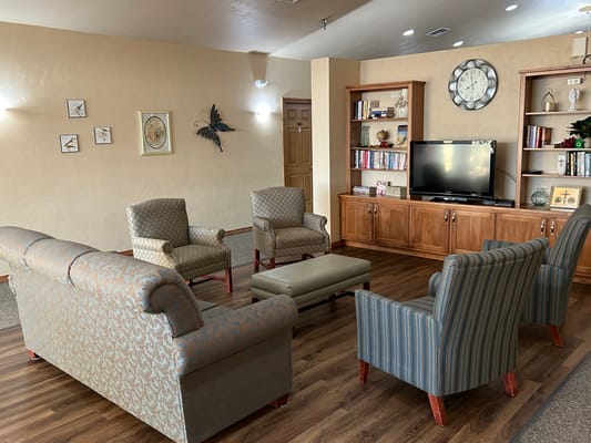 Comfortable common area with seating and a TV