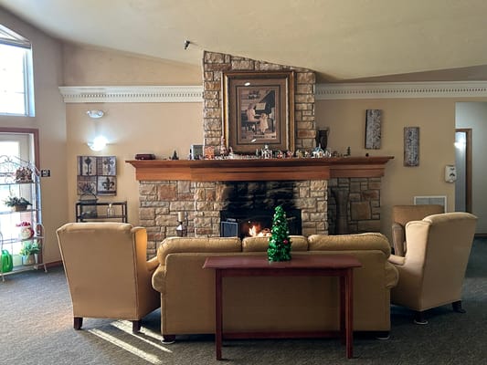 Cozy common area with a fireplace and holiday decor