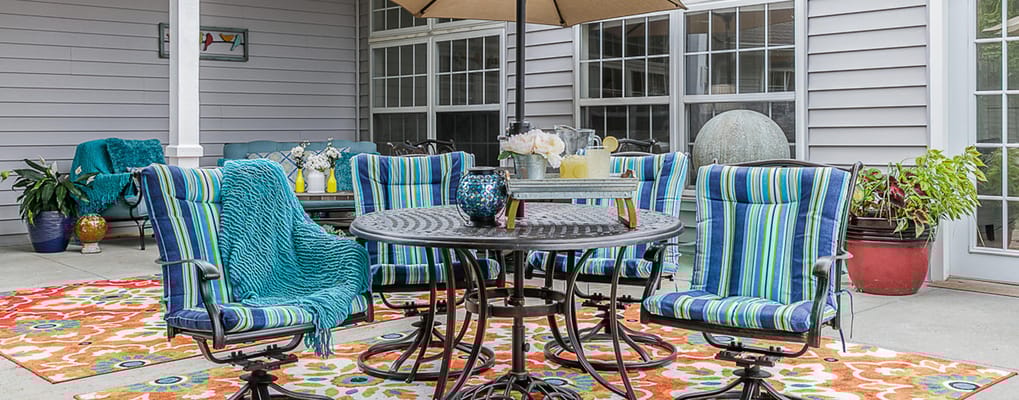 Outdoor seating area with colorful furniture and décor
