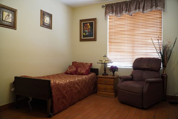 Cozy resident room with bed and armchair