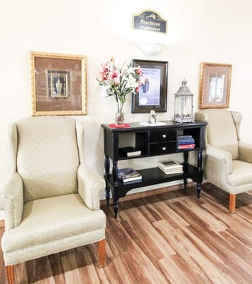 Seating area in the Peachtree Neighborhood with two chairs and decorative furnishings